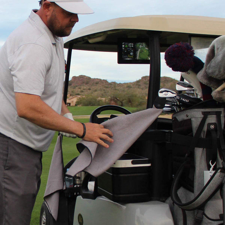 Golfer wiping his hands with the Golf Microfiber Waffle Towel at the cart