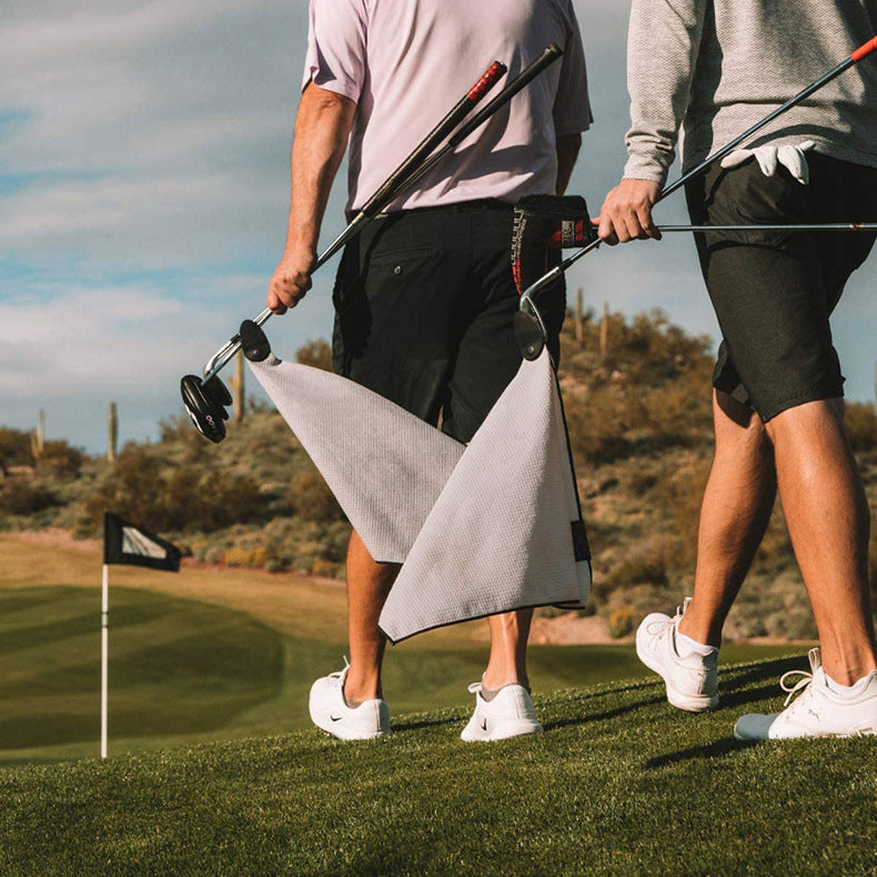 Golf Microfiber Waffle Towel hanging from a golf bag on the course
